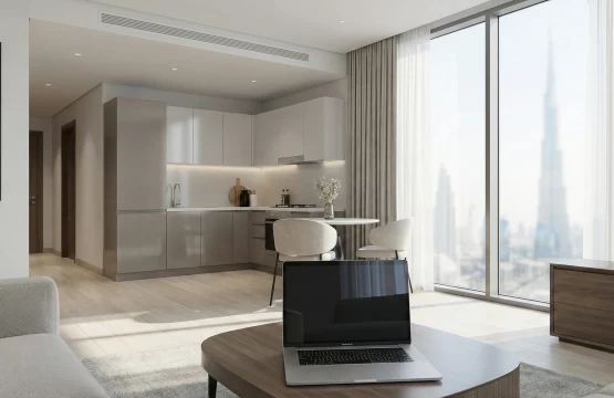 Modern serviced apartment living room in Dubai with skyline view and kitchenette.